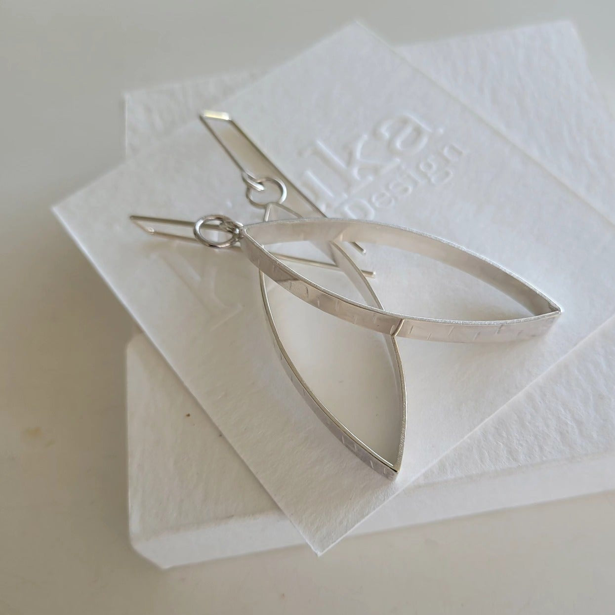 silver dangling earrings.