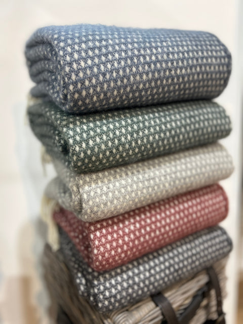 Shopology Knut Woven Wool Throws. These beautiful and luxurious woven wool throws are made with New Zealand lambswool which can be traced back to the individual farm. The Knut blanket features a subtle woven spot design with contrasting cream fringing. Soft and cosy lambswool has been sourced from sheep farmers in New Zealand using high, eco-friendly standards. They keep you warm on cold winter days or nights and become a nice and timeless detail on your sofa or bed. Available at www.shopology.co.nz 