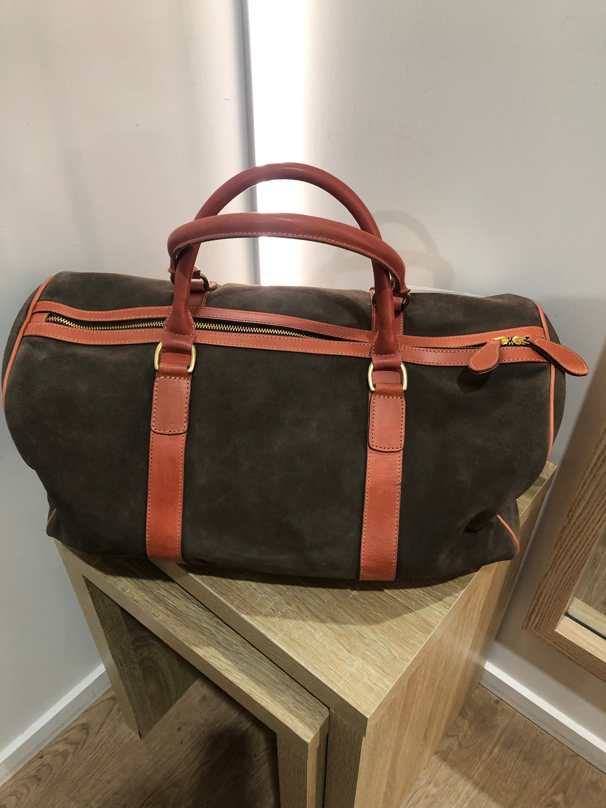 Baxter Travel bag available shopology Christchurch CBD.  Baxter travel bag in Chocolate suede wth tan leather trimming, double zip closure, with two open pockets and a zip pocket inner, two outside side pockets.&nbsp; Bag can be hand held or held over the shoulder with shoulder strap. Perfect size for a weekend away.  length 50cm, width 23cm, height 25cm.