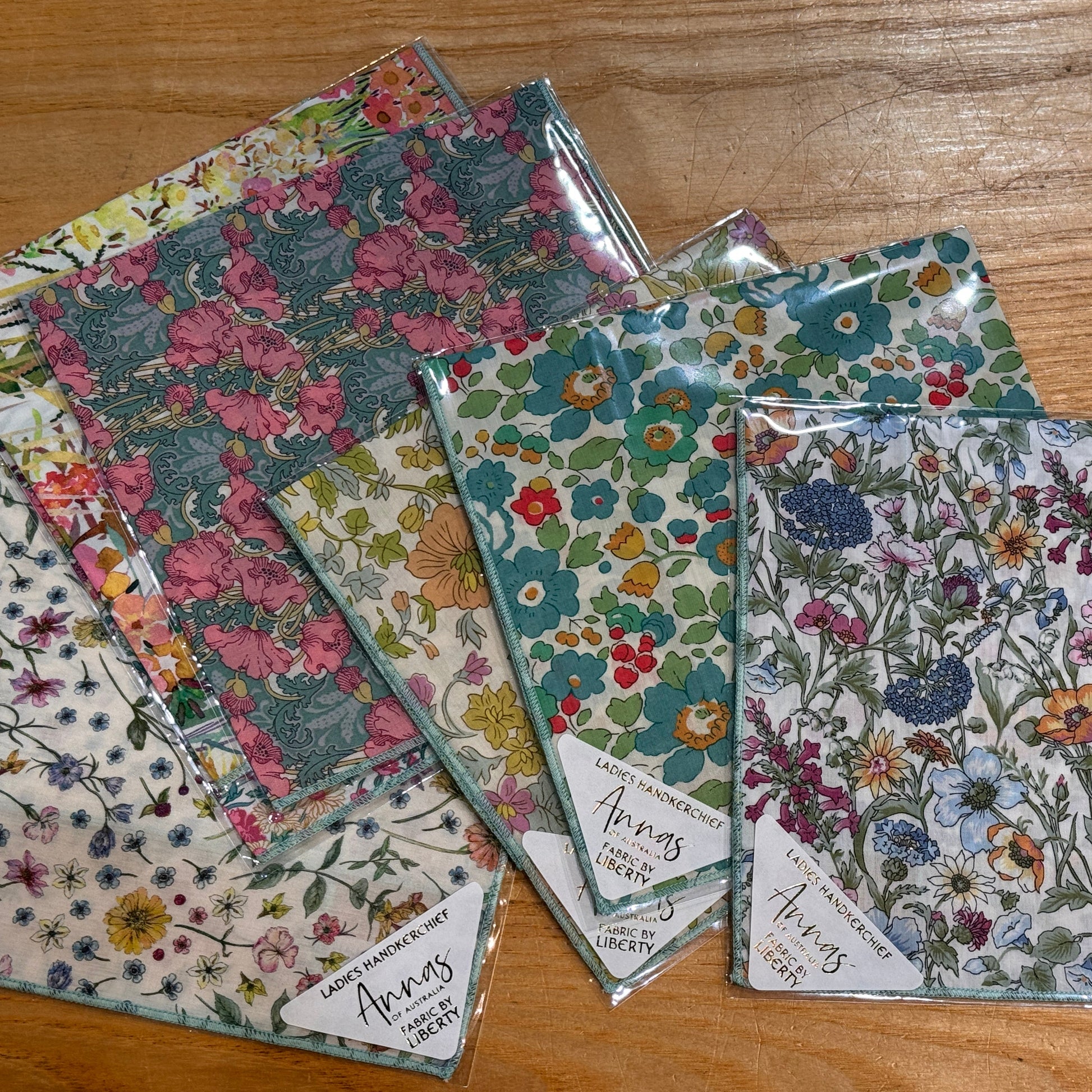 cotton hankies with floral patterns, predominantly green.