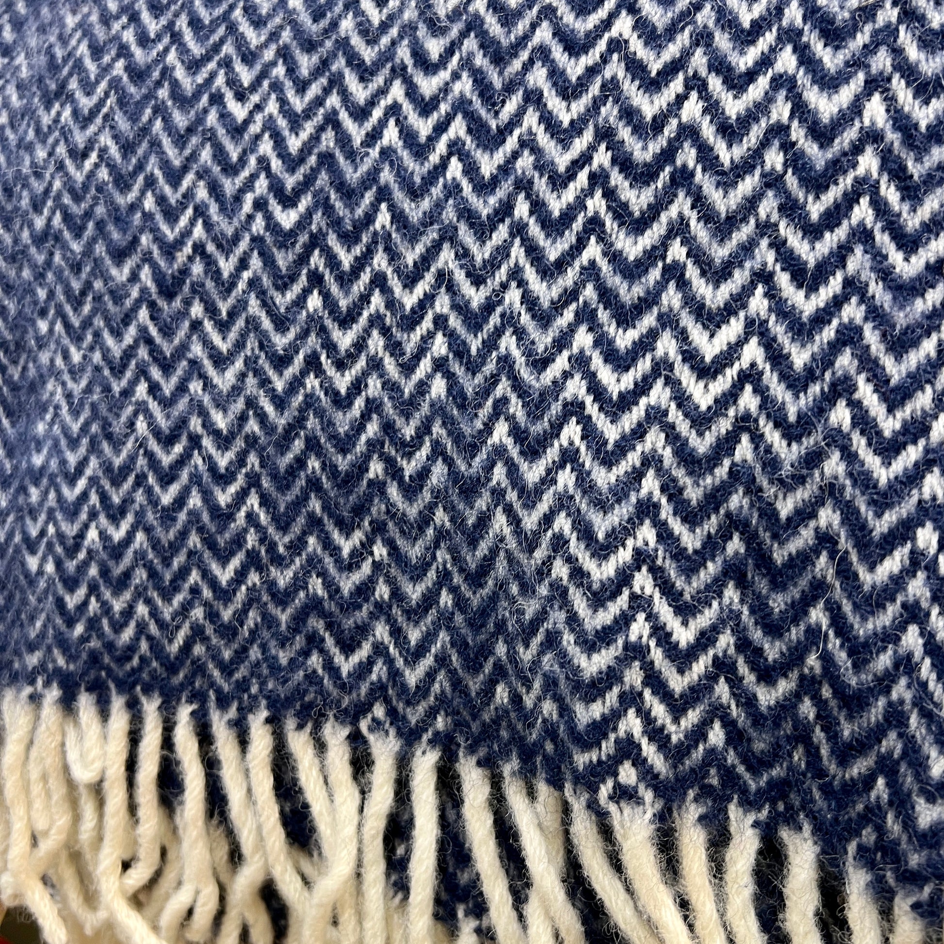The Chevron blanket features a subtle woven 'chevron' pattern with contrasting cream fringing. Available at www.shopology.co.nz