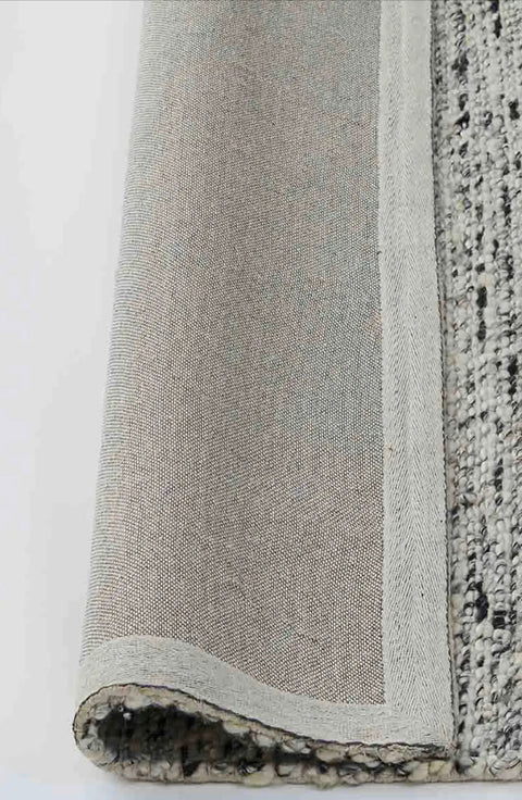Available exclusive shopology, Christchurch CBD. Hand-woven with a bouclé-texture look 90% Wool and 10% Viscose Ethically hand-woven by artisans, the Dolomite rug is simply exquisite. This chameleon of a rug will blend effortlessly into any interior space, from classic to contemporary. Dolomite Pepper features a trending bouclé look, with salt and pepper tones speckled throughout.
