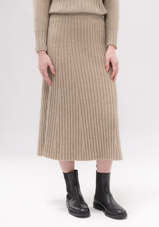 Emilia Knit Skirt Merinomink available shopology. This sophisticated skirt is set to be a favourite. With a comfy elasticated waist and flattering elongating rib.The Skirt skims the body falling perfectly. Crafted with Untouched Worlds signature Merinomink blend, this cosy combination offers a stylish, monochromatic look.   50% merino, 40% possum, 10% mulberry silk Long length Ribbed knit Elasticated waist Made in Christchurch, New Zealand Available size Small, Medium, Large