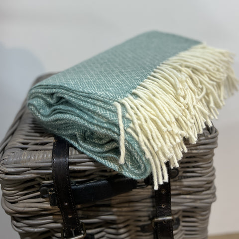Buy this beautiful Sage green blanket, made from 100% soft pure lambs wool, grown, spun and woven entirely in New Zealand.  Perfect as a comforter for a double or queen bed, a throw on the sofa or to keep warm in the car as a travel rug.  100% natural lambs wool, quality, sustainable, ethical and traceable to the NZ farm.  Shopology has an extensive collection of blankets and throws to choose from in store and online. We love to support New Zealand farmers and natural fibres.