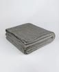 Luxurious Throw exclusive Ecopossum blend, Untouched World, 50% merino, 40% possum & 10% mulberry silk blend, made in New Zealand, premium blend of fine ZQ certified merino, brush tail possum, featherweight softness with warmth & durability, pill resistant, eco & sustainable, gift, New Zealand wool product, knitwear, wool, washable, Shopology, tourist, sustainable, stylish, natural, merino yarn, lightweight, itch-free, fashion, easy-care, local, exclusive CBD, made in Canterbury.  www.shopology.co.nz
